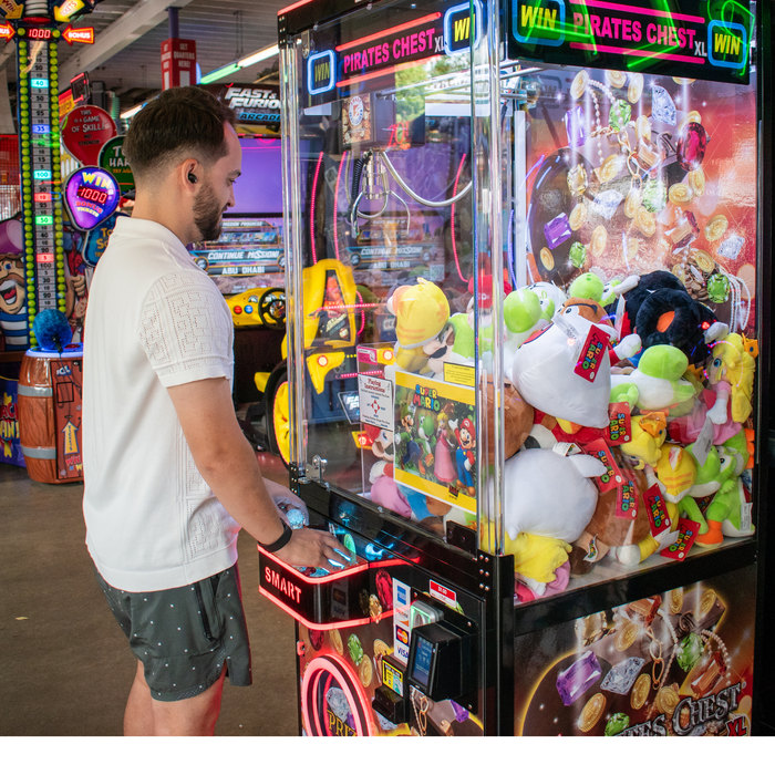 Man playing arcade game with Engage Pulse card reader