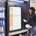 Woman making a payment on a Go Max kiosk